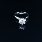 A DIAMOND SINGLE STONE RING. THE ROUND BRILLIANT DIAMOND IN A SIX CLAW RAISED SETTING UPON A PLAIN