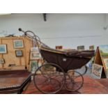AN ALBERT YEATES DOLLS PRAM TOGETHER WITH AN IRON FIRE FORK
