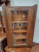 A SMALL OAK BOOKCASE WITH LEAD GLAZED DOORS