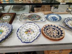 A COLLECTION OF SPANISH ALBALAT POTTERY DISHES TOGETHER WITH TWO CLOCKS WITH CERAMIC FACES