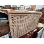 A LINEN BASKET CONTAINING TWO WASTE PAPER BASKETS, A MIRROR AND A GREY WOOL RUG