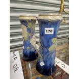 A PAIR OF DOULTON STONEWARE VASES DECORATED WITH WHITE ROSES