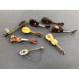 A COLLECTION OF VINTAGE TORTOISE SHELL MUSICAL INSTRUMENTS TOGETHER WITH A SIMILAR FORM BROOCH.