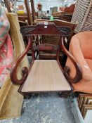 AN EARLY 19th C. MAHOGANY ELBOW CHAIR WITH FOLIATE CARVED HORIZONTAL BAR BACK, THE REEDED FRONT LEGS