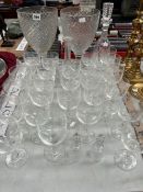 DRINKING GLASS, DECANTERS AND A PAIR OF OVOID VASES ON STEPPED SQUARE FEET
