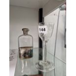 A SILVER MOUNTED CLEAR GLASS HIP FLASK AND CRESTED CUP TOGETHER WITH AN 18th C. WINE GLASS