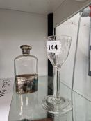 A SILVER MOUNTED CLEAR GLASS HIP FLASK AND CRESTED CUP TOGETHER WITH AN 18th C. WINE GLASS