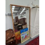 A LARGE ANTIQUE WALL MIRROR WITH GILDED FRAME.