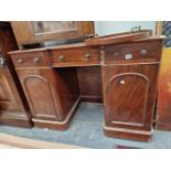 A SMALL VICTORIAN MAHOGANY KNEEHOLE DRESSING TABLE STAMPED NUTTALL & SONS