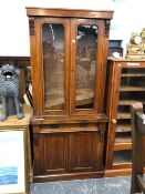 A VICTORIAN ROSEWOOD CABINET, THE UPPER HALF GLAZED OVER SHELVES, THE BASE WITH PANELLED DOORS. W 88