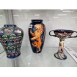 TWO MOORCROFT VASES TOGETHER WITH A TWO HANDLED STANDING CUP