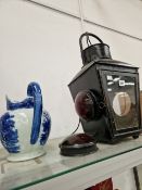 A GLAZED BLACKENED METAL LANTERN TOGETHER WITH A BLUE AND WHITE JUG