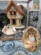 A PENDELFIN COUNTRY COTTAGE TOGETHER WITH A BABY RABBIT SLEEPING IN A CAVE ROOM