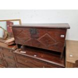 A LATE 17TH CENTURY OAK PLANK COFFER WITH SHALLOW CARVED DECORATION