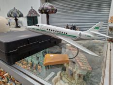 A SCALE MODEL FALCON 2000 JET AEROPLANE WITH A STAND AND PACKING CASE