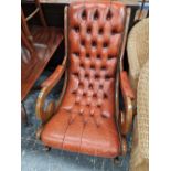 A BUTTON LEATHER UPHOLSTERED ROCKING CHAIR.