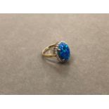 AN OPAL AND DIAMOND CLUSTER RING. UNHALLMARKED, STAMPED 375, ASSESSED AS 9ct GOLD. WEIGHT 3.53grms.
