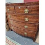 A REGENCY MAHOGANY AND CROSSBANDED BOW FRONT CHEST OF 5 DRAWERS