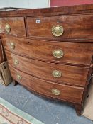 A REGENCY MAHOGANY AND CROSSBANDED BOW FRONT CHEST OF 5 DRAWERS