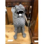 A BLACK PAINTED TERRACOTTA SEATED LION ROARING. H 62cms.