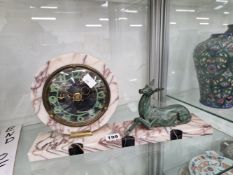AN ART DECO SPELTER AND MARBLE CLOCK, THE CIRCULAR DIAL FLANKED BY A FAUN ON THE RECTANGULAR BASE