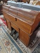 A PEDAL DRIVEN PIANOLA IN A WALNUT CASE