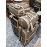 A LARGE SAMSONITE SUITCASE TOGETHER WITH THREE OTHERS COVERED IN TWEED.