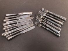 TWELVE HALLMARKED SILVER FISH KNIVES AND FORKS WITH FILLED HANDLES. GROSS WEIGHT 1397grms.