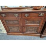 AN EDWARDIAN MAHOGANY SIDEBOARD WITH CARVED PANEL DOORS