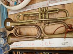 A BRASS TRUMPET TOGETHER WITH TWO BUGLES