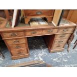 AN EDWARDIAN WALNUT TWIN PEDESTAL WRITING DESK.