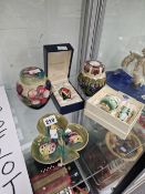 TWO MOORCROFT COVERED JARS, A BOXED VASE, A TREFOIL DISH AND A BOXED ENAMEL EGG CUP AND KNAPKIN