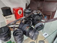 A CASED ZENIT E CAMERA TOGETHER WITH THREE LENSES AND ACCESSORIES