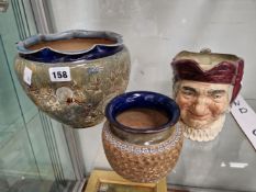 A DOULTON SHELL DECORATED PLANTER, A DOULTON & SLATER SMALLER PLANTER AND A DOULTON CHARACTER JUG