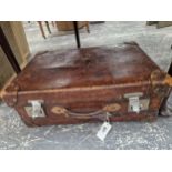 A VINTAGE LEATHER SUITCASE