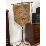 A BRASS TRIPOD SPIRAL TWIST POLE SCREEN WITH WOOL WORK FLORAL BANNER