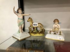 A STAFFORDSHIRE TYPE FIGURE OF A ZEBRA TOGETHER WITH TWO SAMPSON CHERUB FIGURES