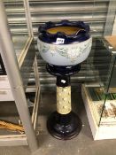 A LANGLEY STONE WARE PLANTER ON STAND DECORATED IN TWO TONES OF BLUE