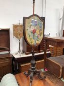 A VICTORIAN ROSEWOOD POLE SCREEN, THE SHIELD SHAPED FRAMED NEEDLE WORK BANNER WORKED WITHA VASE OF