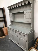 A GOOD QUALITY PAINTED PANEL DOOR DRESSER AND PLATE RACK
