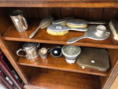 A SILVER BACKED DRESSING TABLE SET, A SILVER TEA STRAINER VARIOUS PLATED WARES, BAROMETER ETC.