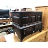 AN EARLY COUNTRY OAK COFFERETTE WITH TWO DRAWER BASE.