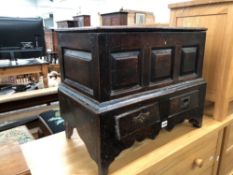 AN EARLY COUNTRY OAK COFFERETTE WITH TWO DRAWER BASE.