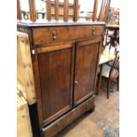 A 19th C. OAK CABINET WITH A DRAWER ABOVE TWO DOORS AND A FURTHER DRAWER ABOVE THE BRACKET FEET. W