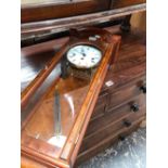 A COMITTI YEW WOOD CASED THREE TRAIN WALL CLOCK CHIMING ON RODS. H 66cms.