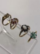 AN EMERALD AND DIAMOND CLUSTER RING, SET IN SILVER GILT. FINGER SIZE L 1/2 TOGETHER WITH THREE