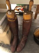 A PAIR OF BROWN RIDING BOOTS WITH THEIR TREES