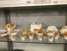 A SHELLEY TEA SET DECORATED WITH ORANGE AND YELLOW DAISIES
