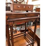 A NEST OF TWO MAHOGANY TABLES BOTH WITH FLUTED COLUMN LEGS, THE UPPER TABLE WITH A DRAW OUT LEAF