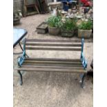 A GARDEN BENCH WITH BLUE PAINTED IRON SUPPORTS`